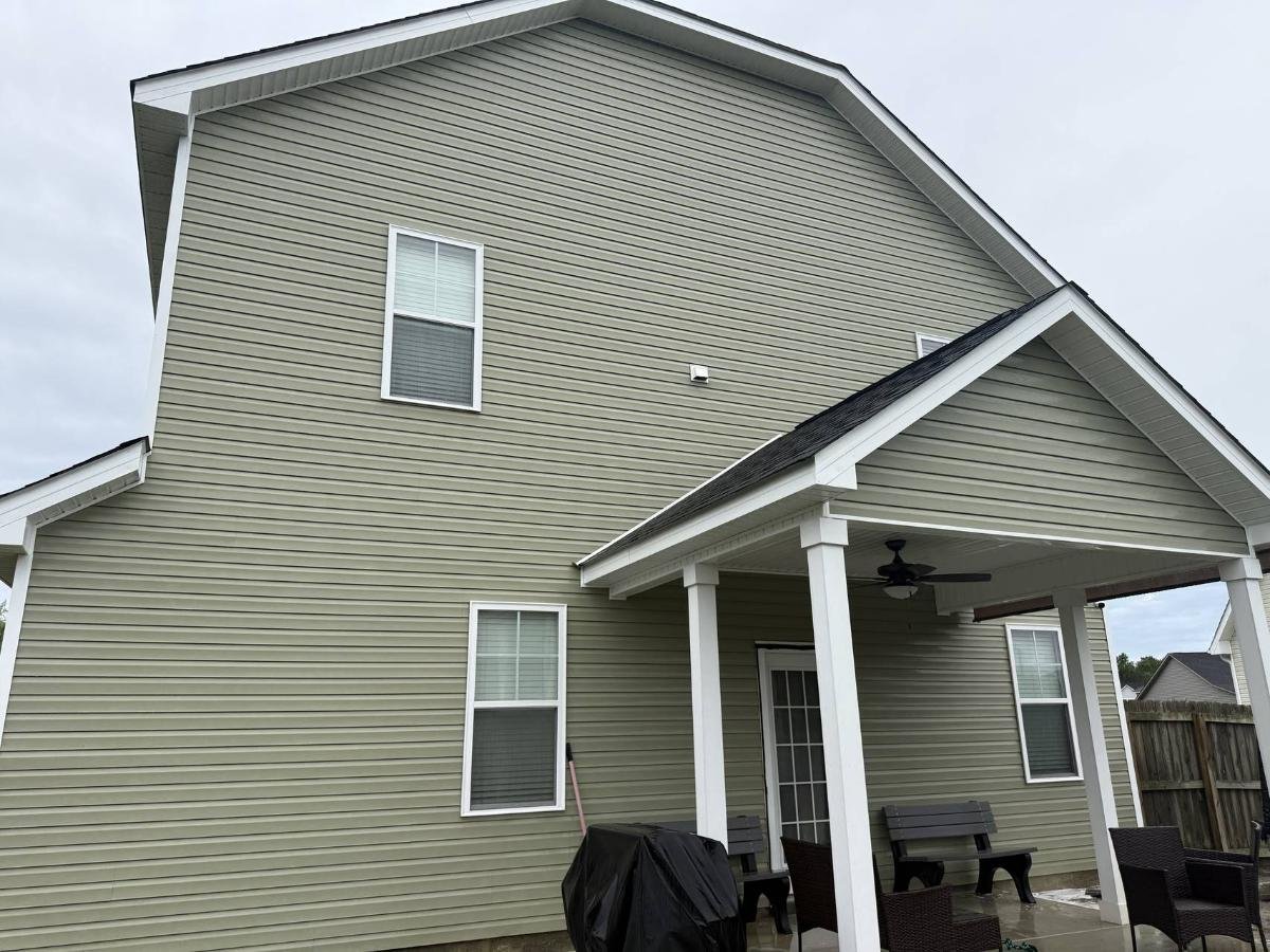 Dramatically cleaned house siding after pressure washing, showing restored appearance and curb appeal