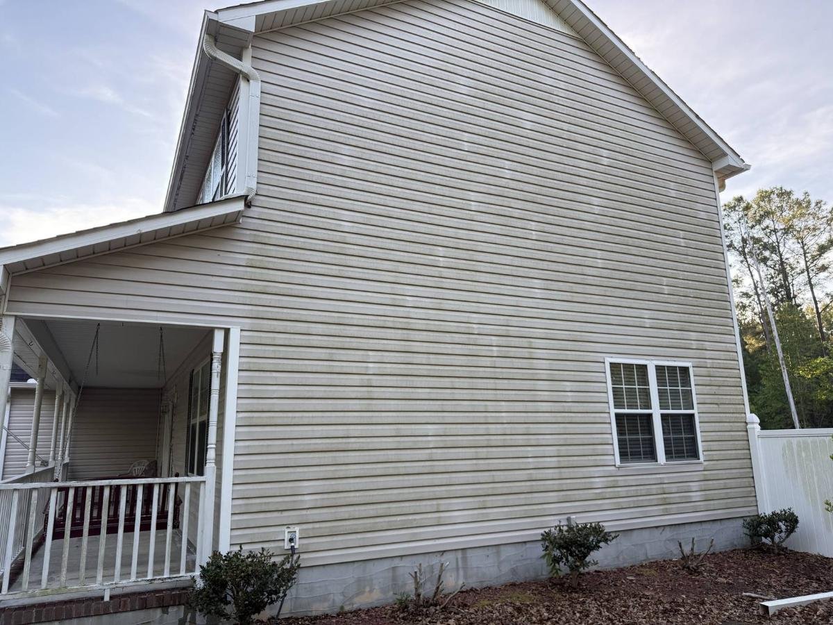 House exterior before pressure washing showing dirt, grime, and mildew stains on siding