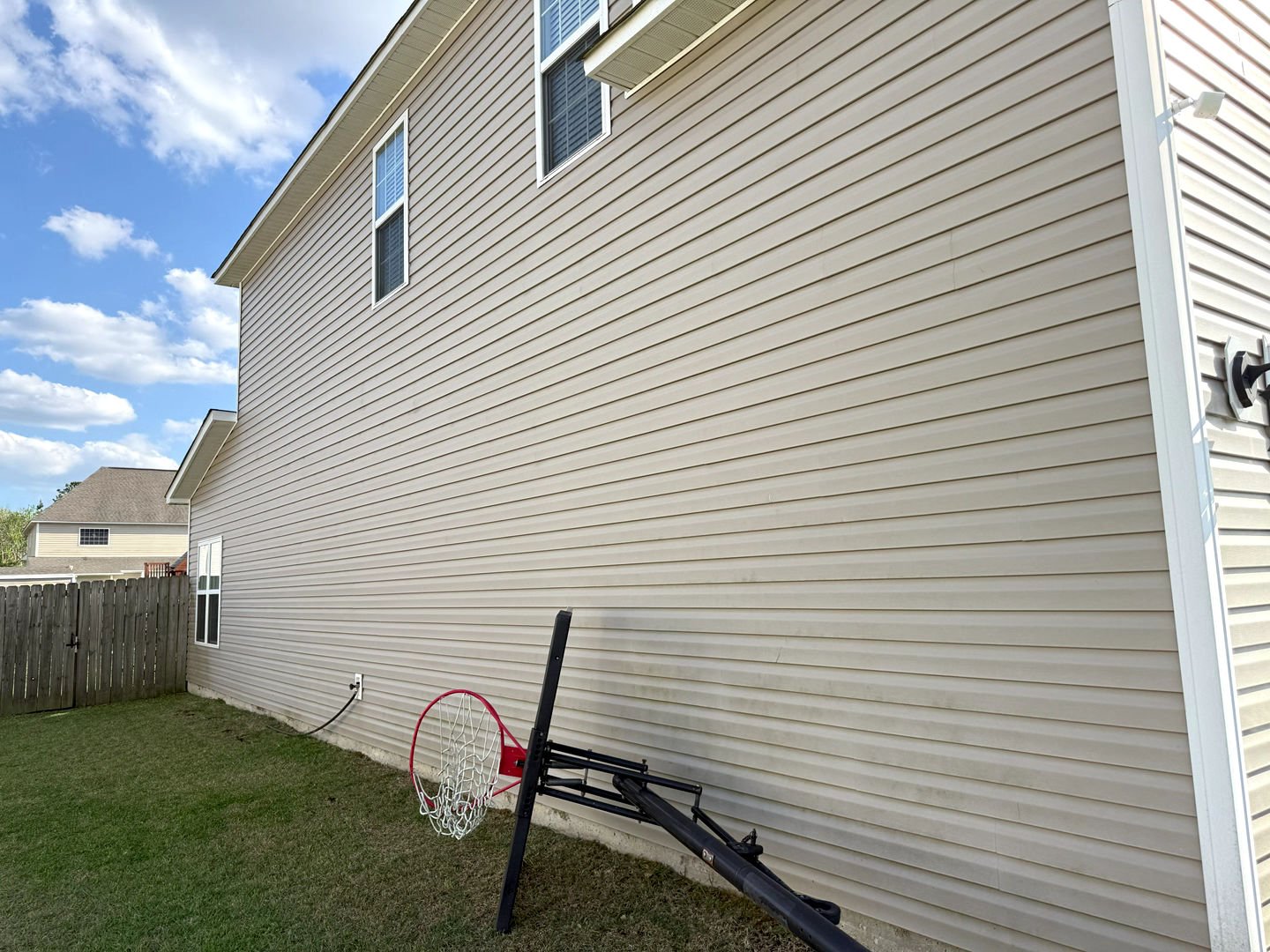 Pressure washing a house's siding, showcasing a clean and refreshed exterior with minimal dirt and grime.