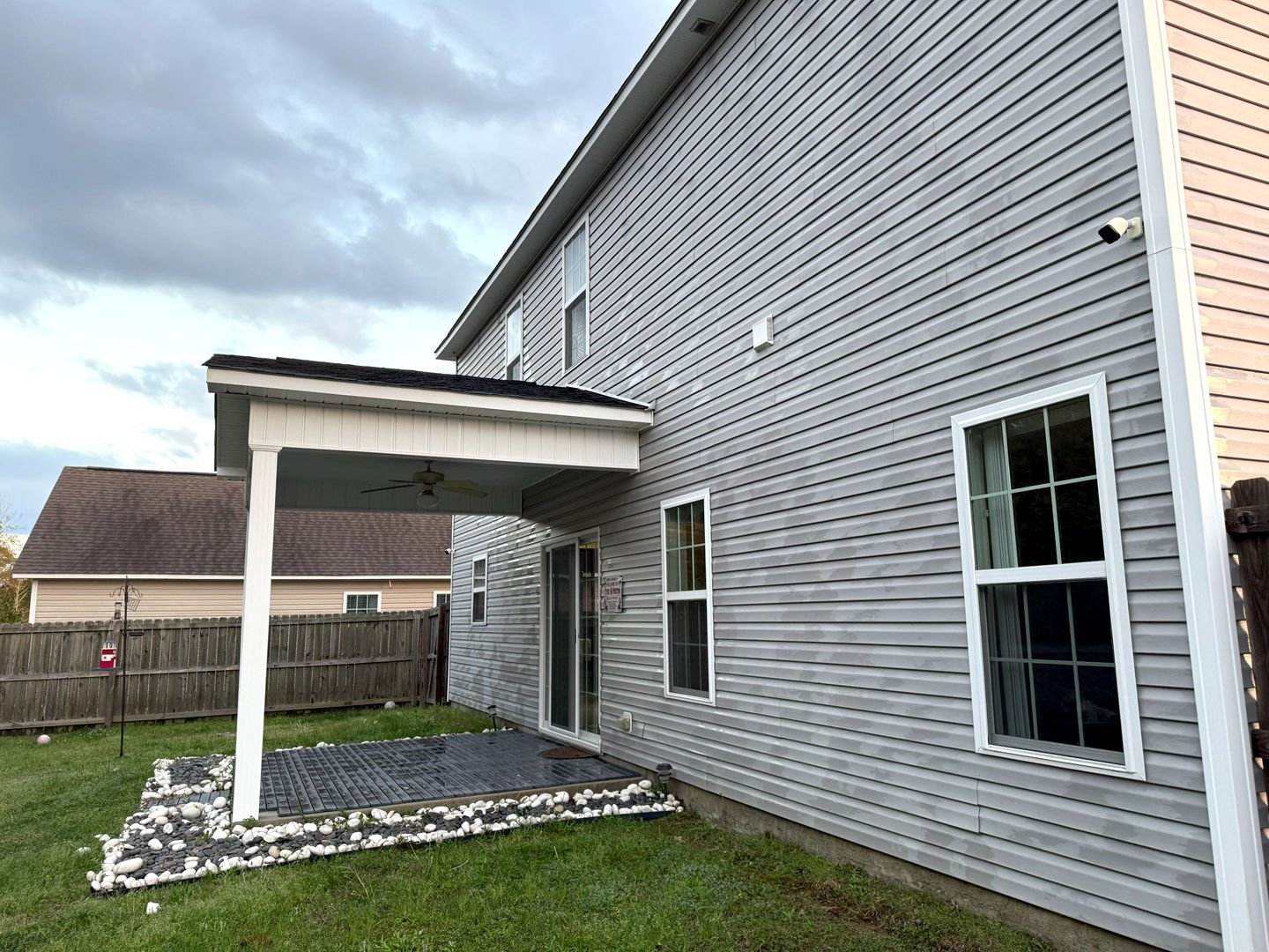 Pressure washing transformed the dirty vinyl siding of a house, restoring its clean, bright appearance and enhancing curb appeal.