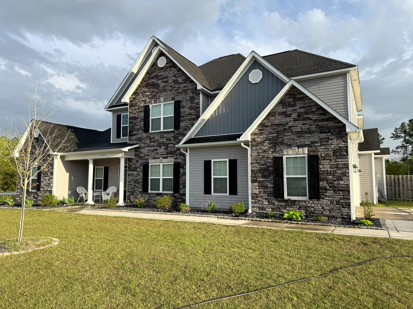 Pressure washing transformed this home's exterior, restoring the vibrant stonework and siding to a like-new condition.