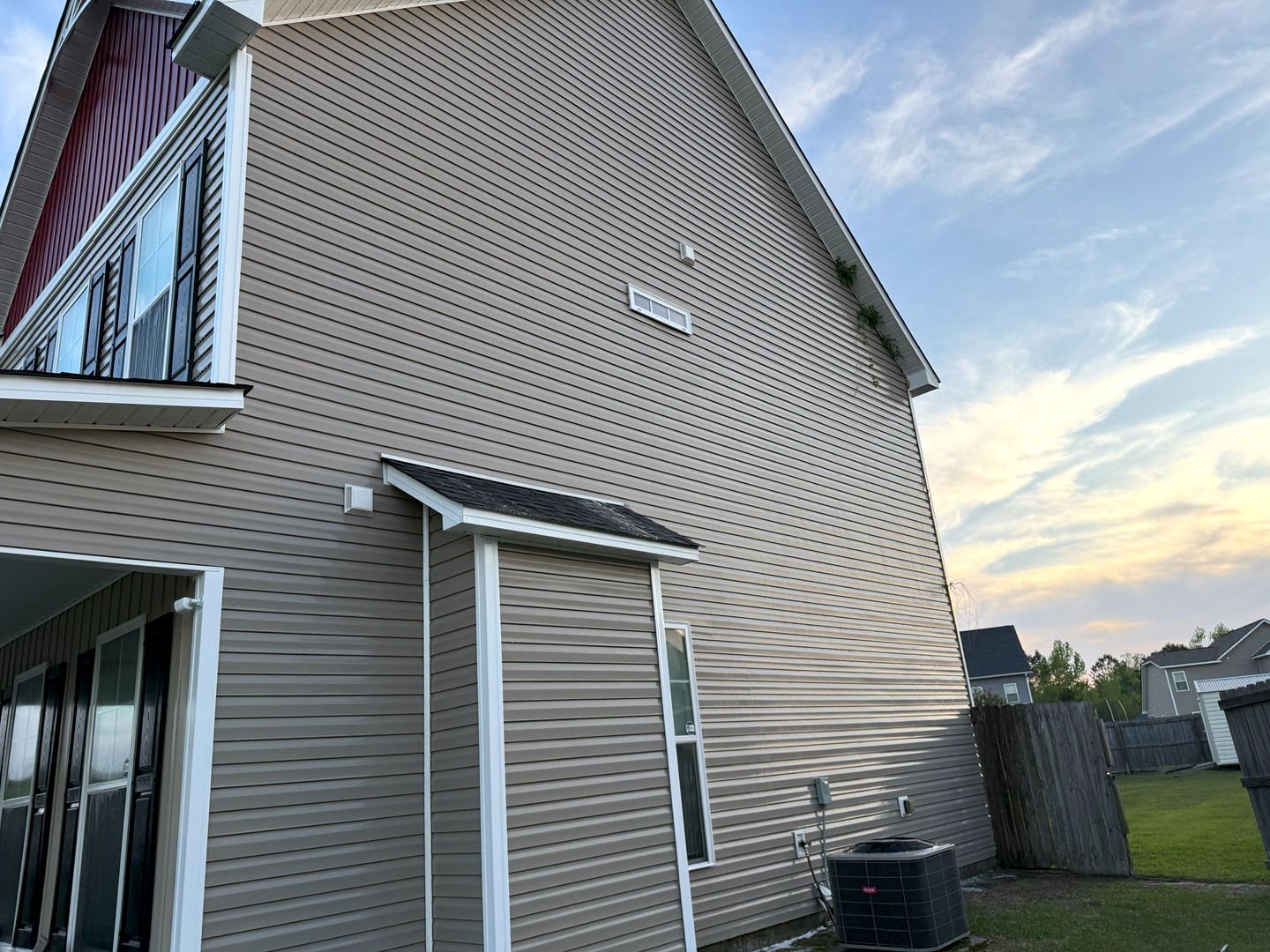 Pressure washing revitalizes this home's vinyl siding, removing dirt and grime for a fresh, clean appearance.