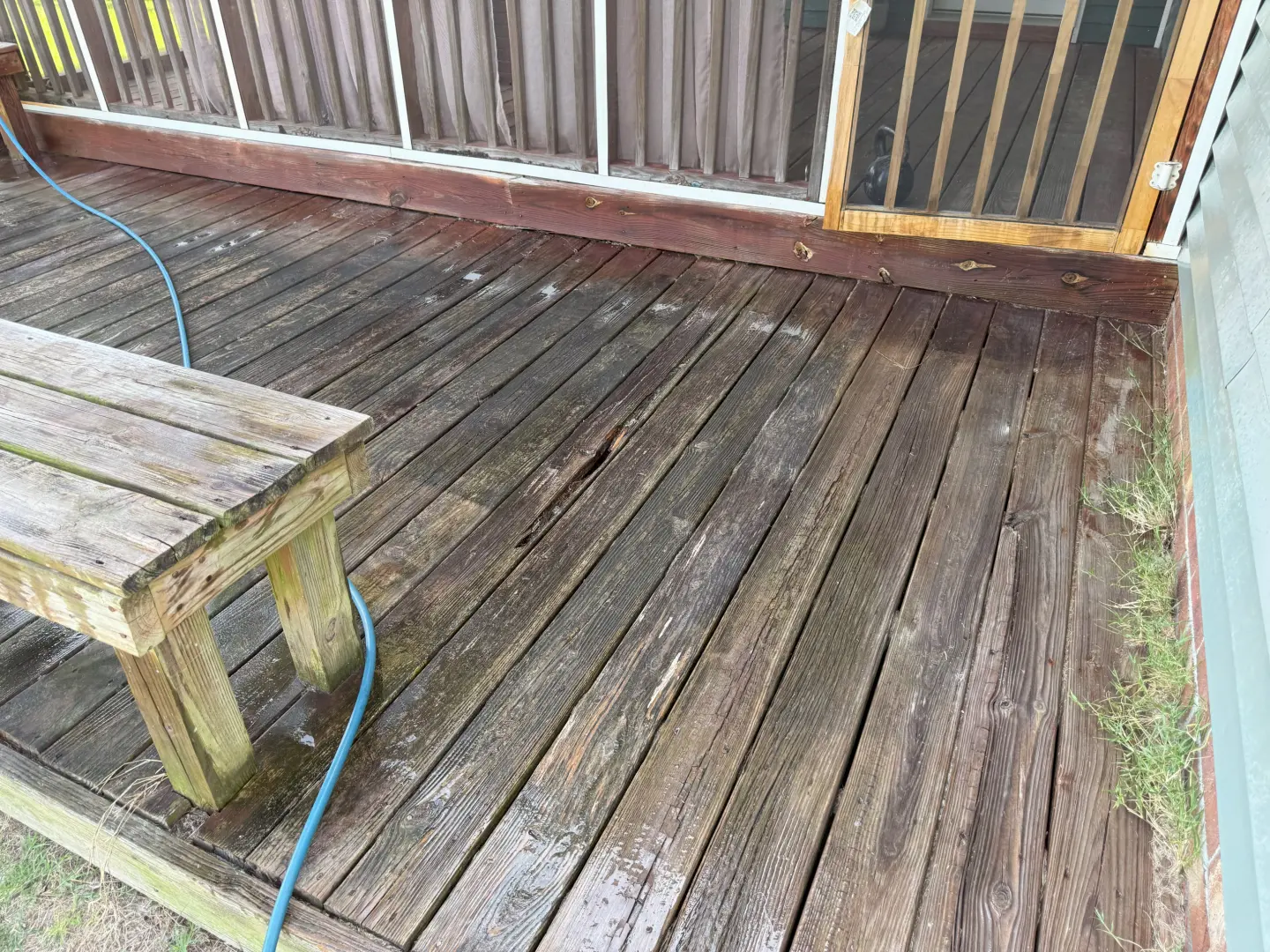 Pressure washing a wooden deck reveals clean, revitalized boards alongside dirt and grime removal.
