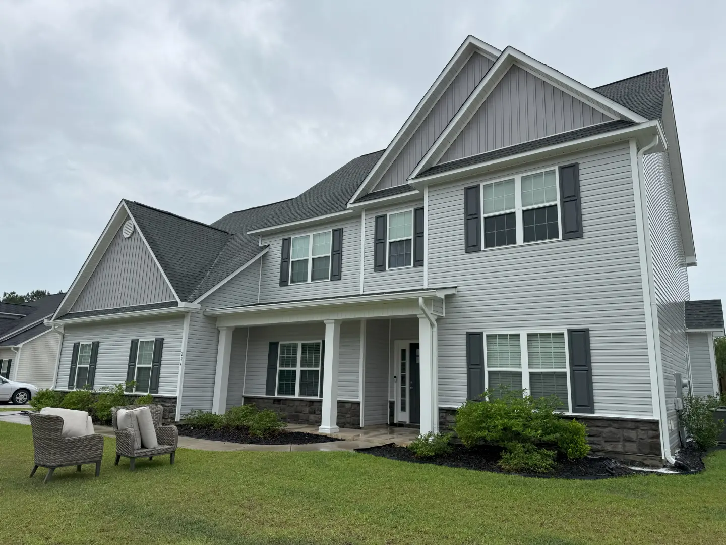 Pressure washing a home's exterior, revealing a clean and revitalized façade free from dirt and grime.