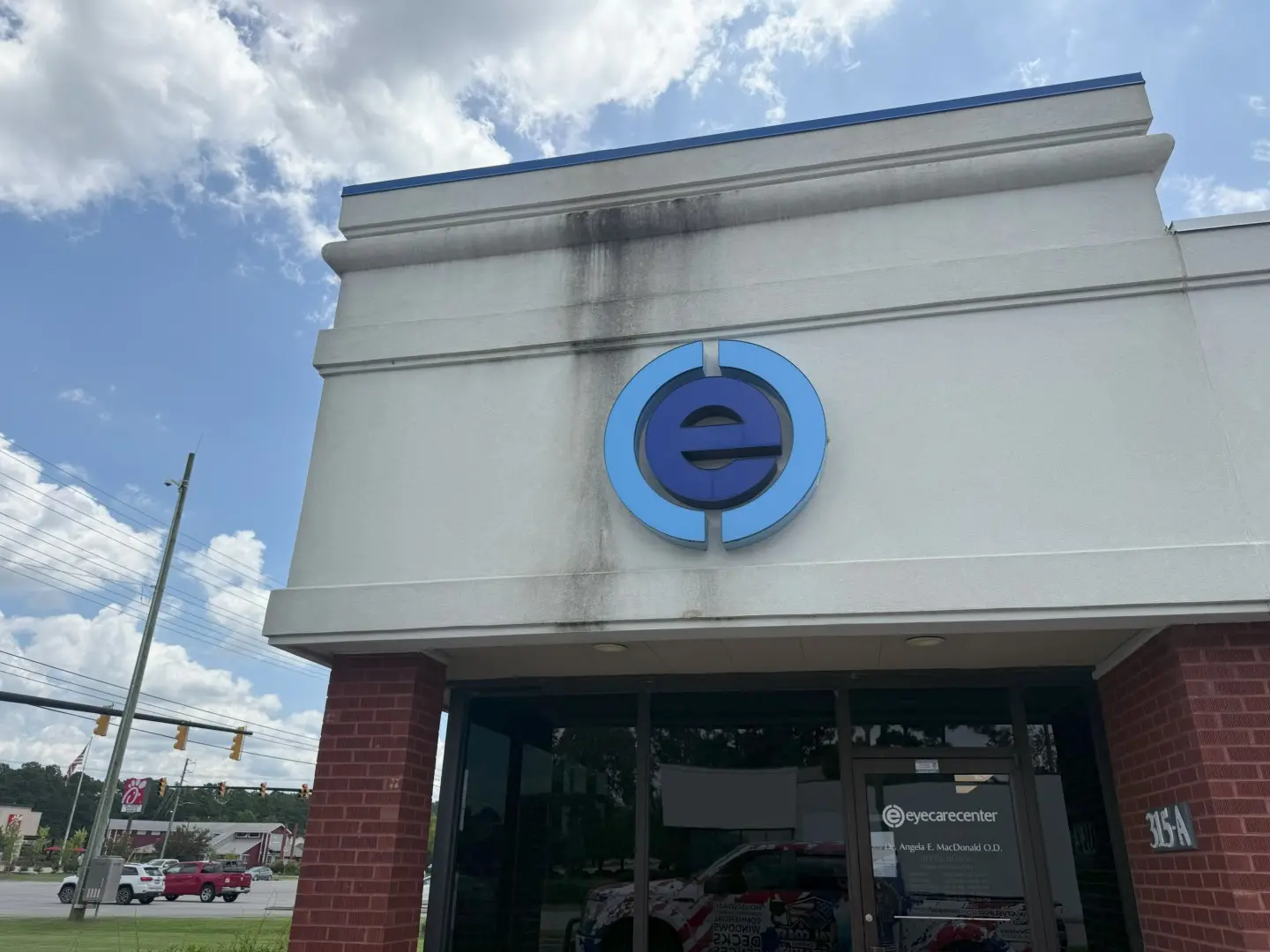 Commercial building exterior with stained walls showing the need for professional pressure washing services.