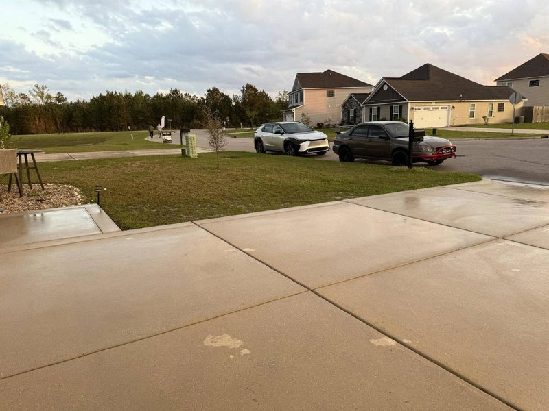 Professional concrete cleaning service removing stains from driveway