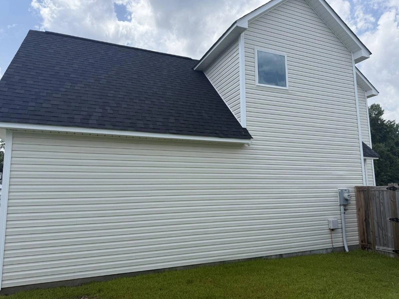 Professional roof cleaning service safely removing algae stains
