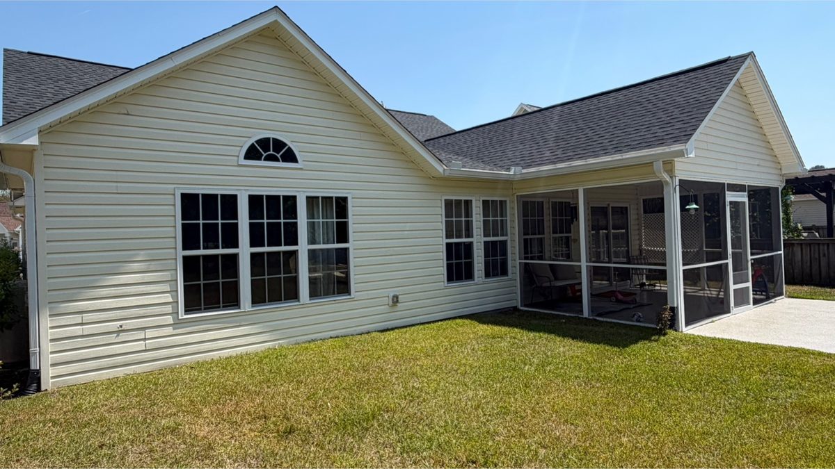 Single-storey home and screened porch before cleaning