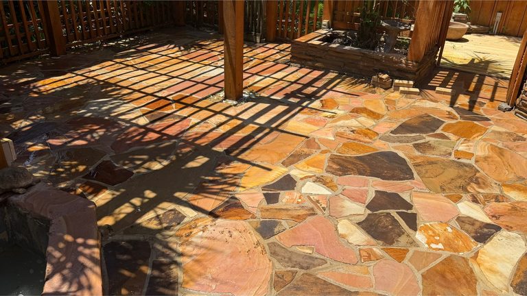 The same flagstone patio cleaned, with the stone colour visible again