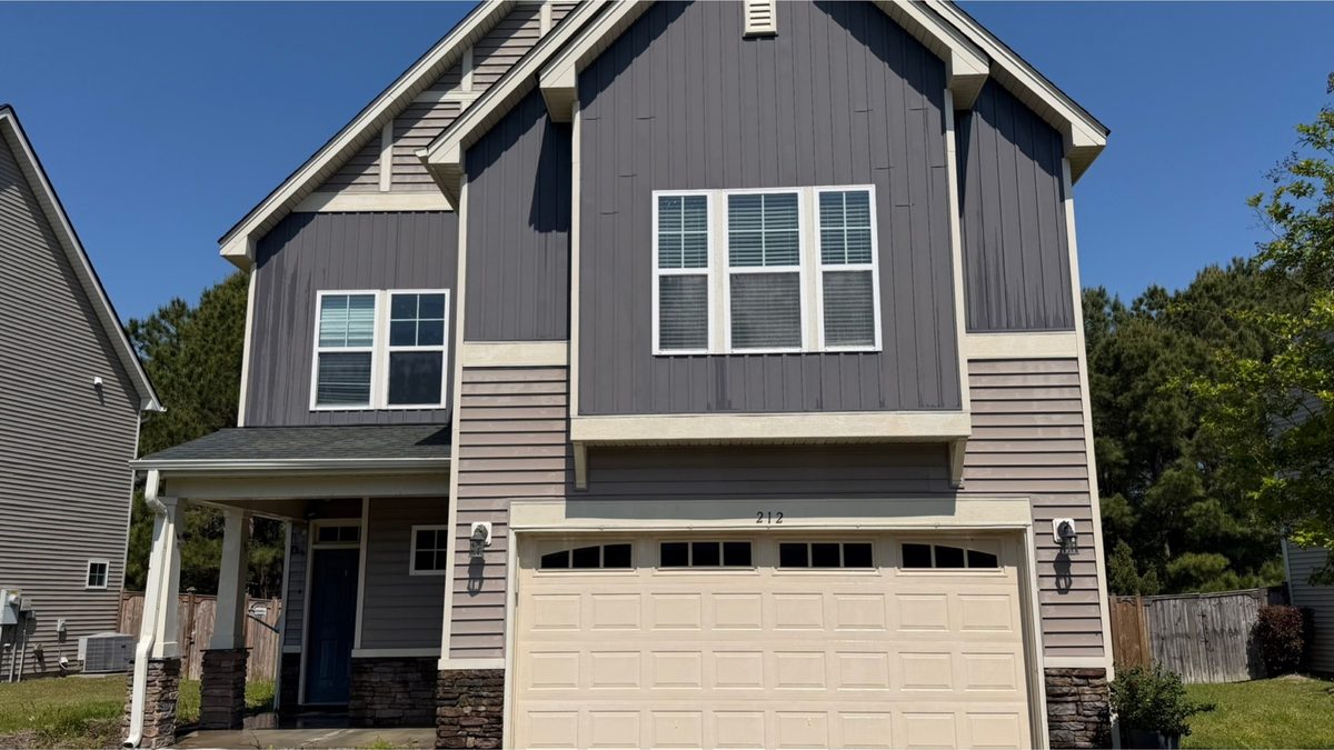 Two-storey home exterior and garage after cleaning