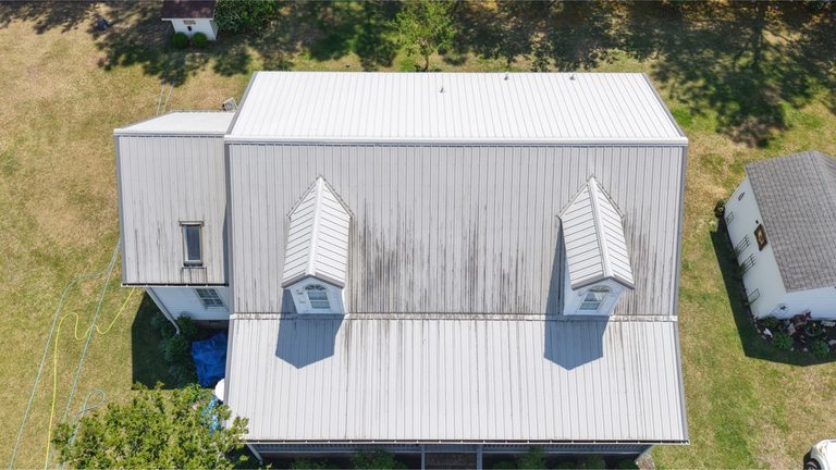 Metal roof and dormers from above before cleaning
