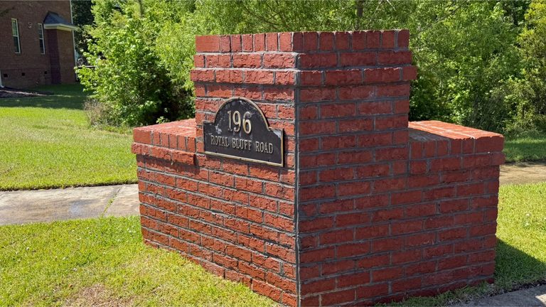 The same monument sign cleaned with the lettering legible again