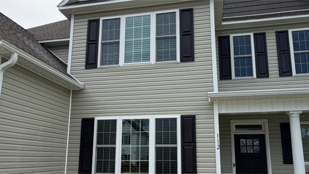 The same home after soft washing, with siding and trim clean and even