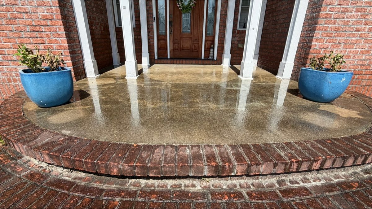 Brick porch and rounded entry steps before cleaning