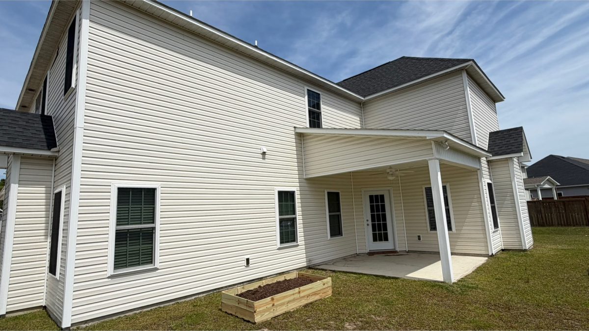 Rear elevation and covered patio before cleaning
