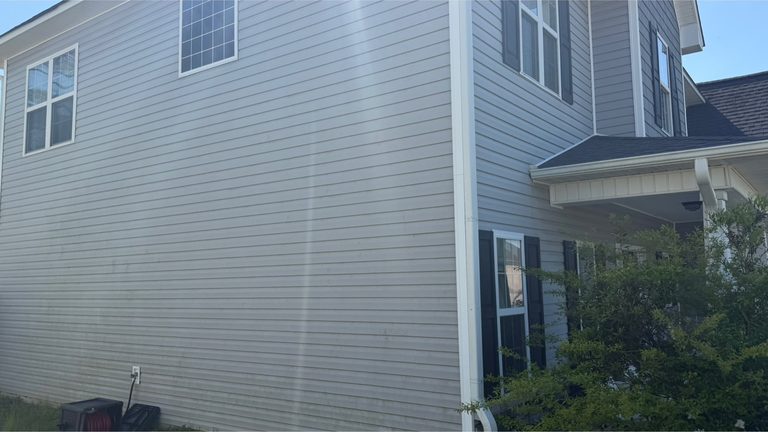 Two-storey siding elevation before cleaning